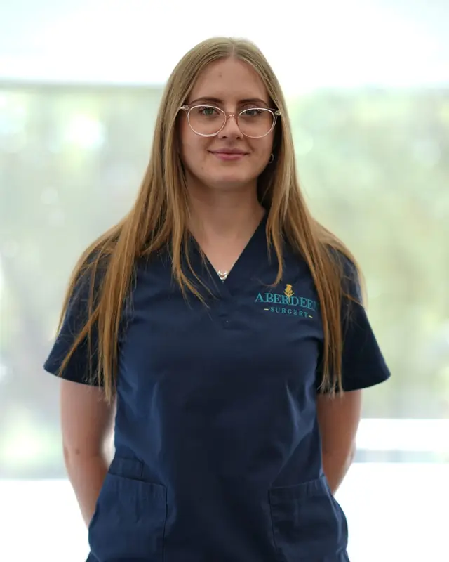 A nurse at Aberdeen Surgery standing by a window